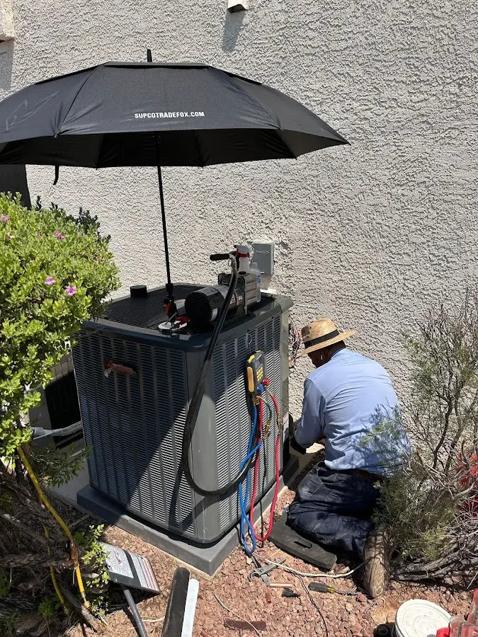 HVAC technician performing outdoor AC maintenance in Jericho